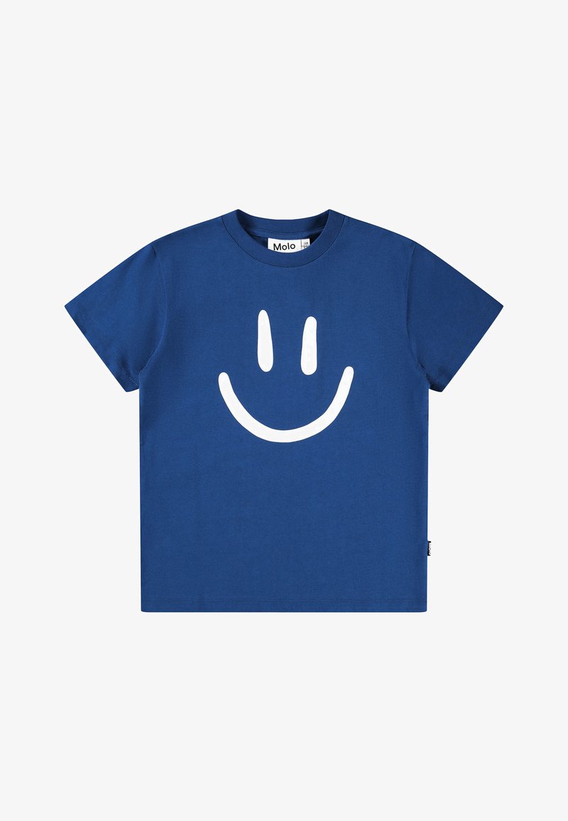 Μπλε βαμβακερό T-shirt με μεγάλη λευκή εικόνα ενός χαρούμενου προσώπου μπροστά. Κοντά μανίκια και στρογγυλή λαιμόκοψη. Ο ετικέτα είναι ορατή από μέσα.