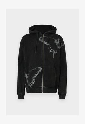 Black zippered hoodie made from soft material, featuring white butterfly prints on the front. Includes a hood and front pockets.