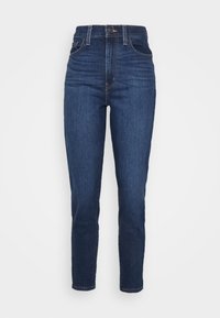 Dark blue high-waisted jeans with a smooth denim texture. Features two front pockets and a zipper with a button closure, tapered leg design.