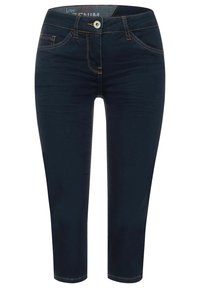 Tummansiniset farkut, kapealla mitoituksella, lyhennetty pituus, kontrastitikkaukset ja nappikiinnitys vyötäröllä. Edessä taskut.