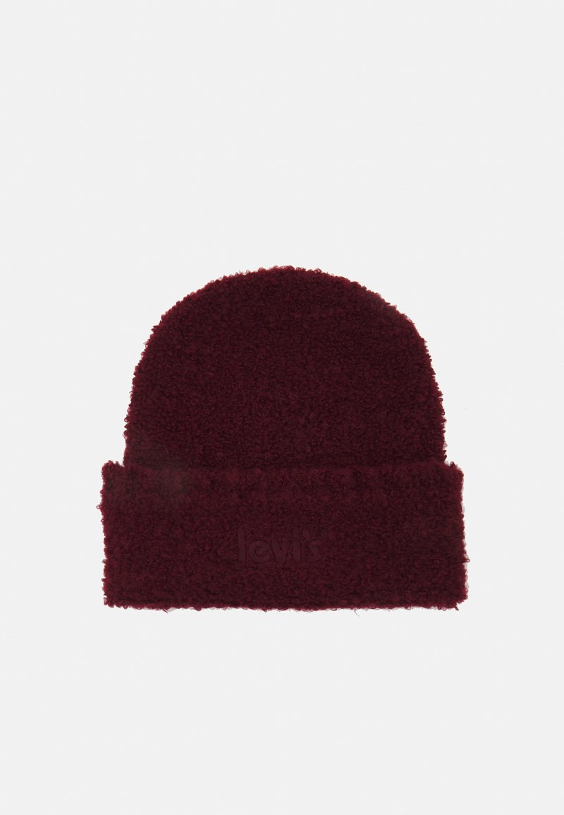 Gorro bordô com um exterior macio e texturizado. A bainha dobrada exibe o logótipo da marca em relevo. Top arredondado para um ajuste confortável.