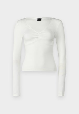 Biela blúzka s dlhým rukávom a výstrihom do V, s riasením na hrudi. Vyrobená z mäkkej tkaniny s priliehavým strihom.