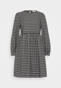 Svart och vit rutigt klänning med långa ärmar, rund halsringning och åtsittande midja. Har en nyckelhålsöppning i ryggen. Material av bomull.