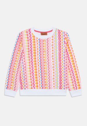 Daugiaspalvė džemperis su zigzago raštu rožinės, geltonos ir mėlynos spalvų atspalvių. Suapvalintas kaklo iškirpimas ir balti elastiniai rankogaliai bei apatinė dalis.