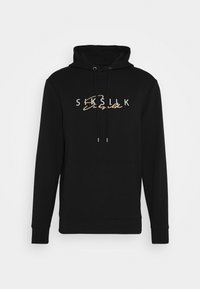 Felpa nera con cappuccio realizzata in misto cotone. Presenta una tasca a marsupio frontale, cappuccio con lacci e un logo testuale bianco/oro sul petto.