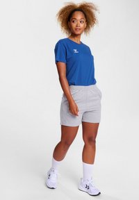 Blue cotton t-shirt with logo, paired with gray shorts. Includes elastic waistband and side pockets. Positioned against a neutral background.