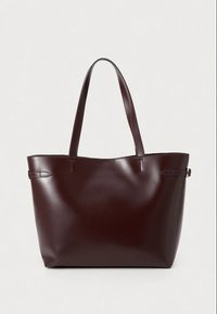 Burgundy leather tote bag with two handles, smooth texture, minimalistic design, and subtle stitching details on the sides.