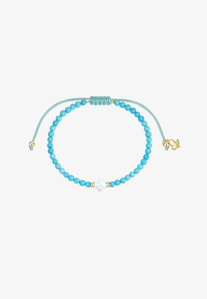 Pulsera ajustable con pequeñas cuentas redondas de turquesa, una cuenta central blanca en forma de flor y detalles dorados sobre un cordón azul verdoso.