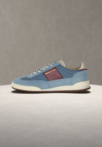 Ανοιχτού γαλάζιου χρώματος αθλητικό παπούτσι με πλευρικό πάνελ σε μπορντό, λευκά κορδόνια, μπεζ γιακά, κρεμ σόλα και χρυσό λογότυπο «PS Paul Smith» στο πλάι.