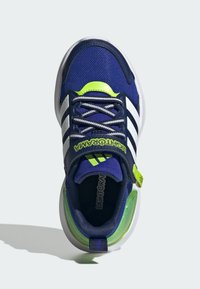 Navy and white athletic shoes with gray laces, a green accent on the tongue, and a textured, cushioned sole. Features prominent branding.