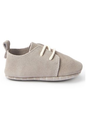 Soft grey suede baby shoe with white laces and a pull-tab at the heel, displayed on a white background.