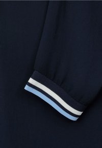Navy blue fabric with a ribbed cuff featuring alternating white and light blue stripes, showcasing a soft texture and simple design.