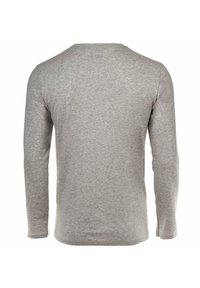 Grijze lange mouw t-shirt van zacht, gestructureerd katoen. Heeft een ronde halslijn en een rechte zoom bij de taille en de mouwen.