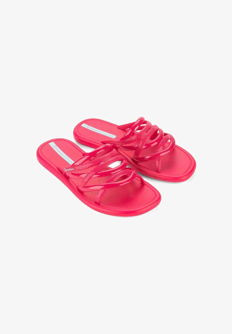 Infradito rosa in gomma caratterizzati da più cinturini incrociati, un footbed testurizzato e una suola piatta con un leggero motivo antiscivolo.