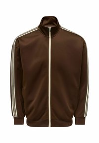 Καφέ φόρμα με λείο ύφασμα, με ψηλό γιακά, πλήρες φερμουάρ και λευκές πλαϊνές ρίγες στα μανίκια. Δύο πλαϊνές τσέπες.