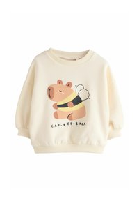 Sweat-shirt couleur crème en tissu doux présentant un capybara dessin animé déguisé en abeille, avec un col arrondi et des manches bouffantes.