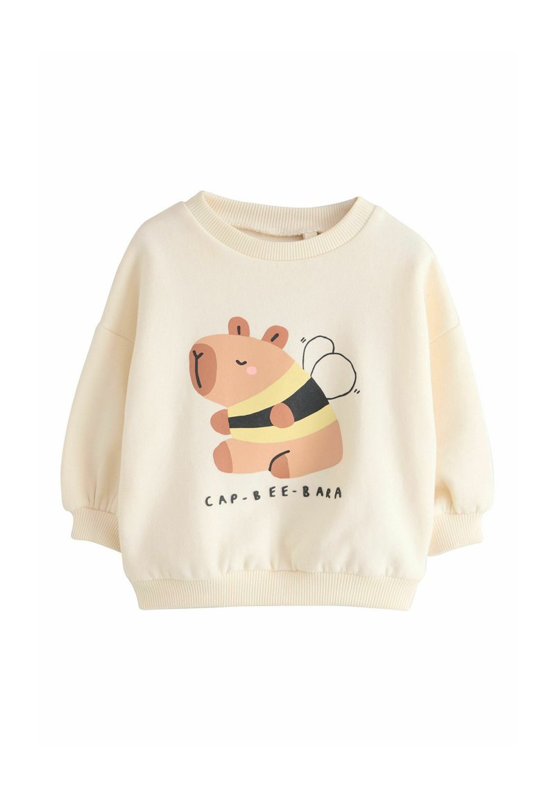 Sweat-shirt couleur crème en tissu doux présentant un capybara dessin animé déguisé en abeille, avec un col arrondi et des manches bouffantes.