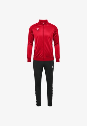 Red tracksuit jacket with high collar and zip, paired with black pants featuring white chevron stripes on the sides. Made of smooth, lightweight material.