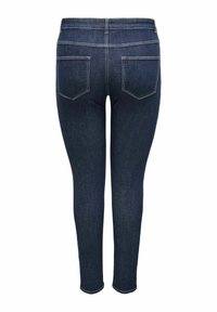 Tmavě modré džíny se slim fit střihem. Mezi hlavními rysy jsou středně vysoký pas, dvě zadní kapsy a prošívání podél švů.