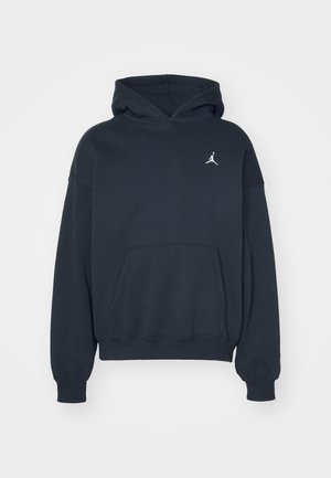 Čierna mikina s kapucňou vyrobená z bavlny, s kloktanou vreckom, vo voľnom strihu a s malým bielym logom Jumpman na ľavej strane hrudníka.