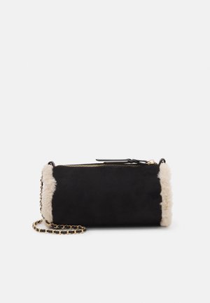 Black cylindrical handbag with beige fur trim on edges and gold chain strap, shown against a plain white background.