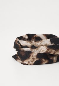 Soft fabric scarf in a tubular shape, featuring a black, brown, and beige animal print pattern with a smooth texture.