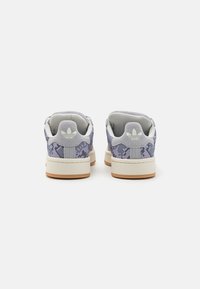 Gray and purple snakeskin-patterned sneakers with a white rubber sole, padded collar, and textured accents. Adidas logo on the heel.