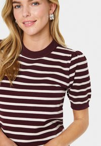 Burgundy and cream striped knit top with short puff sleeves and a round neckline. Soft texture, fitted design, and visible striped pattern.