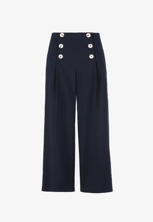 Tumši zili augsta vidukļa plataji bikses ar sešām lielām baltām pogām, kas izvietotas divās vertikālās rindās priekšpusē.