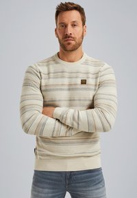 Light beige striped sweater with long sleeves, round neckline, and ribbed cuffs. Features textured horizontal lines in darker shades and a small logo.