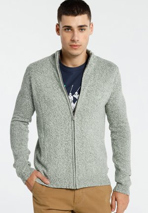 Sweat-shirt zippé gris clair avec un motif de tricot texturé. Il dispose de manches longues, d'un col montant et d'une coupe ajustée.