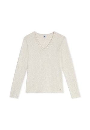 Chemise beige clair à manches longues avec col en V et petit logo rond près de l'ourlet sur fond blanc.