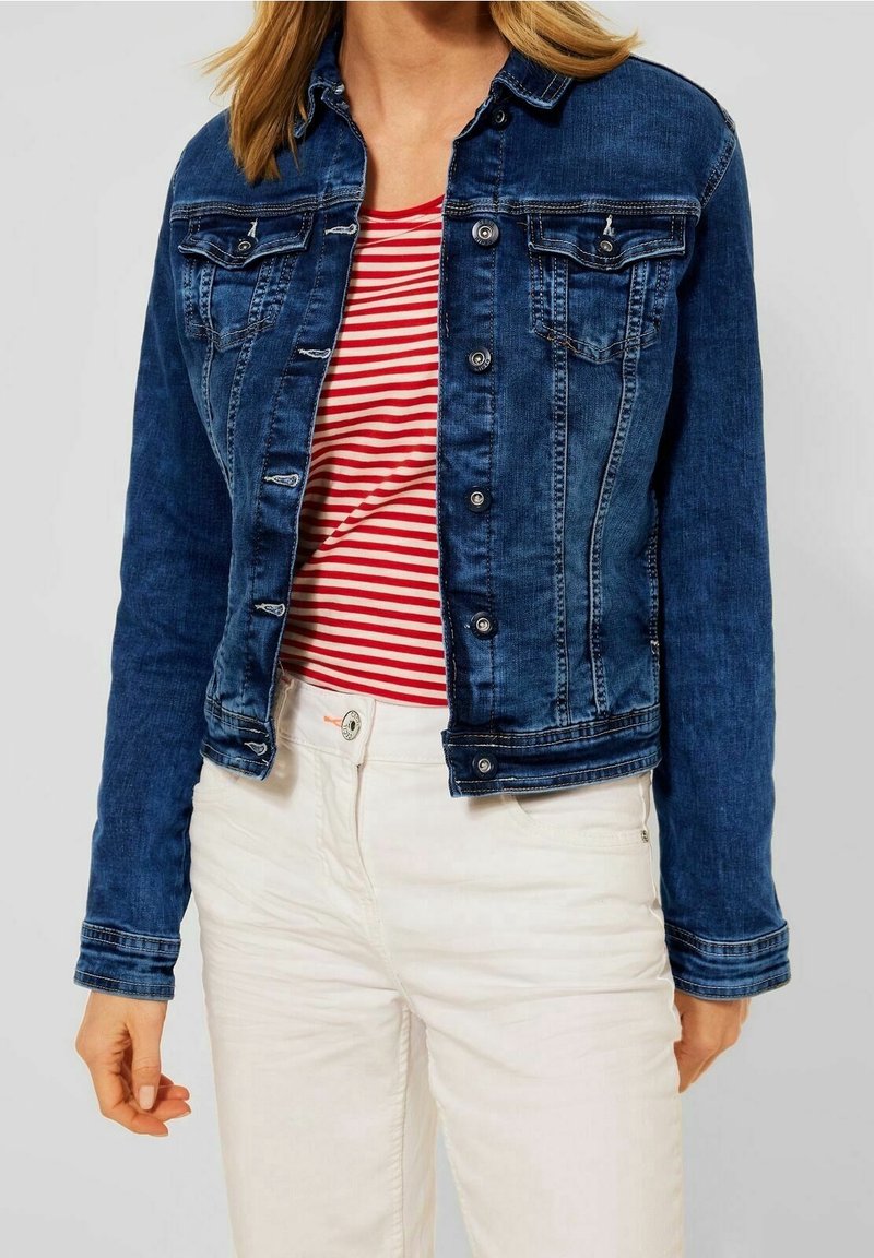 Dark blue denim jacket with button closures, two chest pockets, and light stitching details. Worn over a red and white striped shirt.