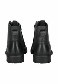 Botas de tobillo de cuero negro con cremalleras laterales, suelas robustas y un logo de Jeep en la parte trasera. Textura suave sin patrones visibles.