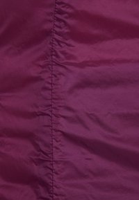 Purple, shiny fabric with a smooth texture, featuring soft folds and a central seam. Material appears lightweight and durable.