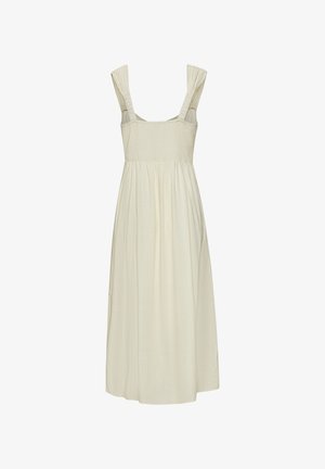 Light ivory dress with a smocked bodice, wide shoulder straps, and flowing skirt. Made from a textured, lightweight fabric.