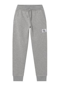 Ljusgrå sweatpants med elastisk midja, dragsko, ribbade muddar, sidofickor och ett litet Calvin Klein Jeans-logotypmärke på vänster ben.