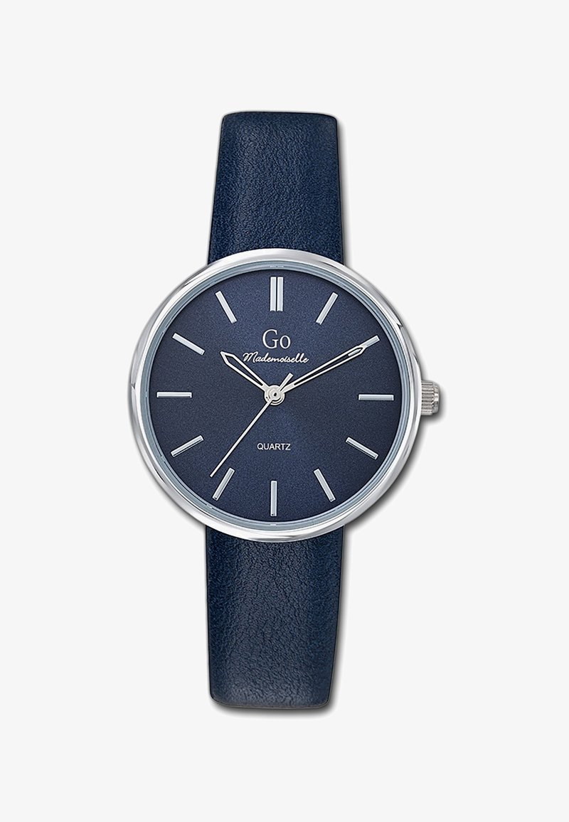 Montre quartz ronde avec un bracelet en cuir texturé bleu foncé, des éléments en métal argenté, et un cadran marine assorti avec des index horaires et le nom de la marque.