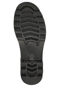 Semelle de chaussure en caoutchouc noir avec un motif texturé comportant des rainures et des crêtes pour l'adhérence, talon plat et sans détails supplémentaires.