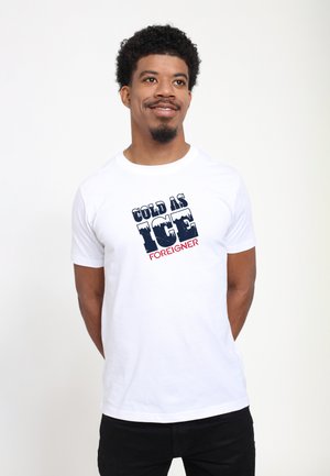 White cotton t-shirt featuring "COLD AS ICE" in navy blue and "FOREIGNER" in red, with a classic crew neck and short sleeves.