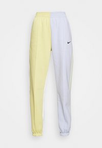Pantalons de jogging bicolores avec un côté jaune et un côté bleu clair. Confectionnés en tissu doux, avec des poignets élastiqués et un petit logo.