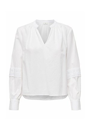Blouse blanche à manches longues avec col en V, col froncé, détails en dentelle sur les manches, et poignets boutonnés.