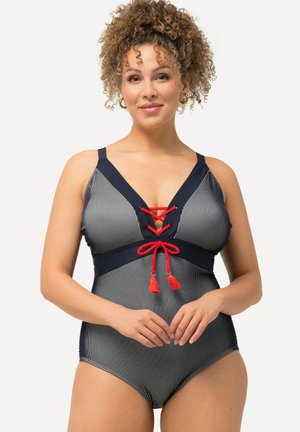 Marineblauwe en witte gestreepte ééndelige zwemoutfit met een diepe V-hals, rode vetersluiting en contrasterende kwastjes. Verstelbare bandjes.