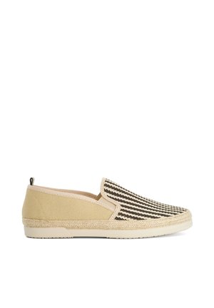 Beige slip-on espadrille with black and white striped fabric upper, braided jute midsole, and rubber outsole.