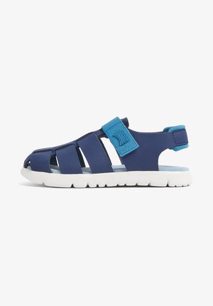 Navy blue sandal made of synthetic material, featuring cut-out design, adjustable strap, and textured sole with white accents.