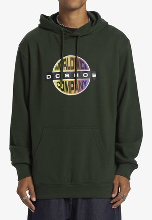 Grön hoodie med en framficka, som har en flerfärgad cirkulär logotyp som inkluderar texten "DC Shoe Company". Tillverkad av bomull, avslappnad passform.