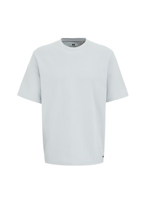 Light blue short-sleeve t-shirt. Soft, textured fabric with a round neckline and loose fit. Minimalist design with no prominent logos or patterns.