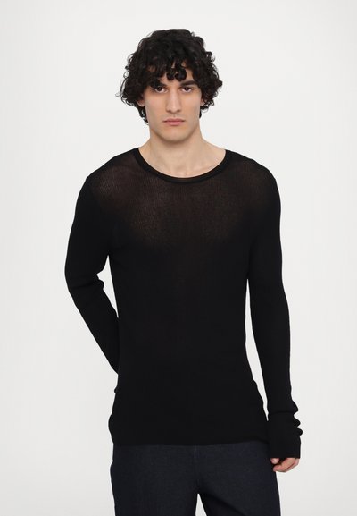 Chemise noire à manches longues en tissu léger et transparent, avec un col rond et des manches cintrées. Le design en tricot texturé ajoute de la profondeur.