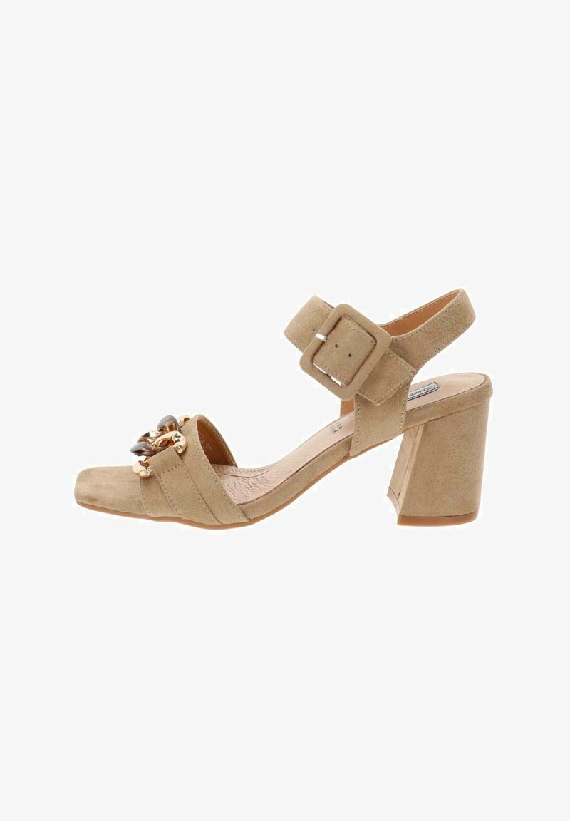 Sandal in suede beige con punta quadrata, cinturino alla caviglia e tacco spesso. Presenta dettagli decorativi sulla fascia anteriore per un tocco in più.