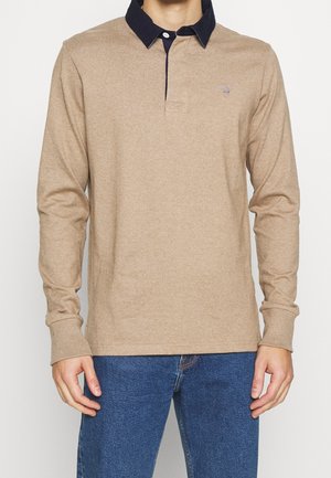 Beige long-sleeve polo shirt with a navy collar, featuring a button placket and a small logo on the chest. Made from soft, textured material.